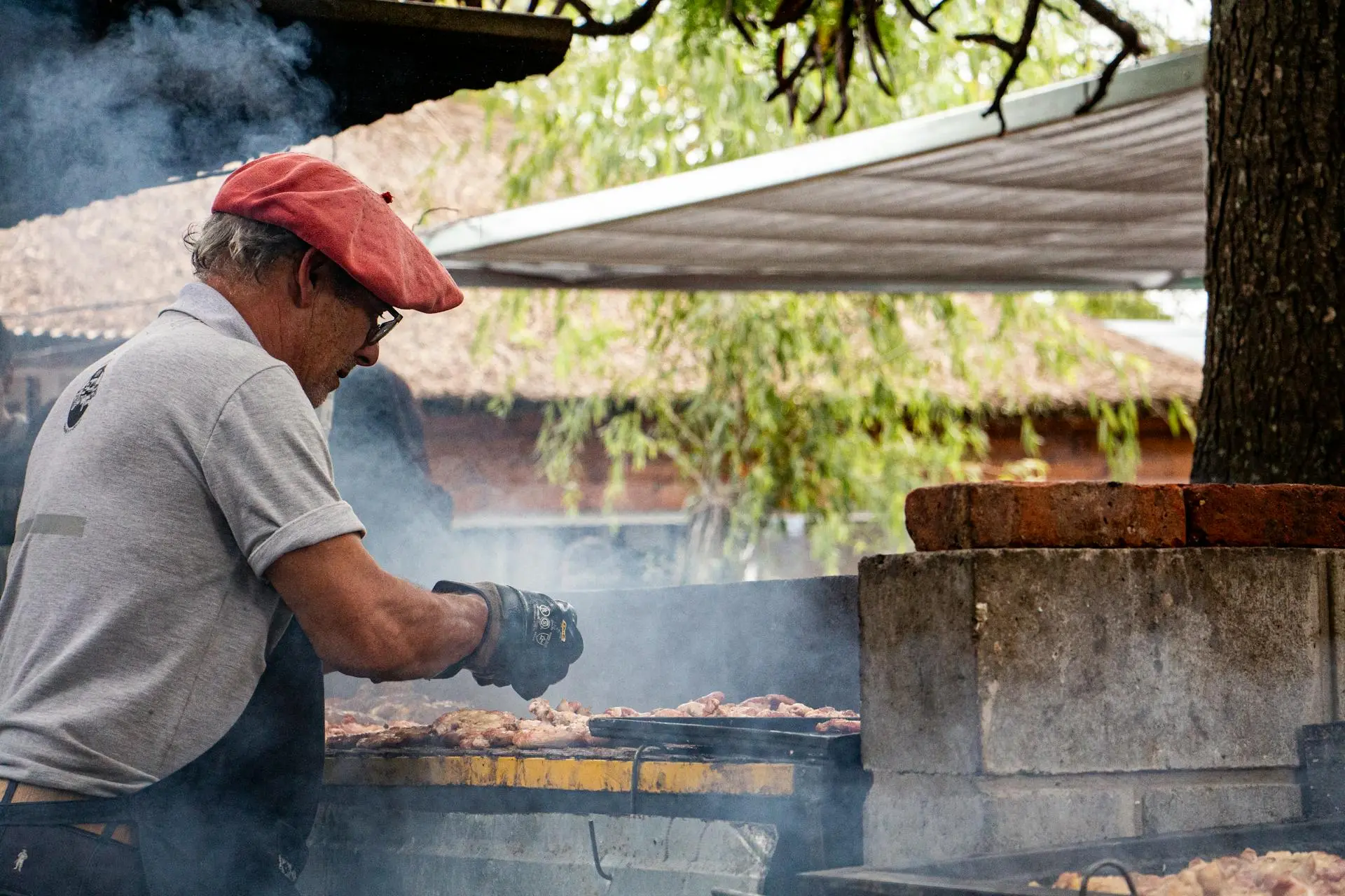 Traveler chopping fresh herbs at an open-air kitchen table surrounded by Manuel Antonio jungle