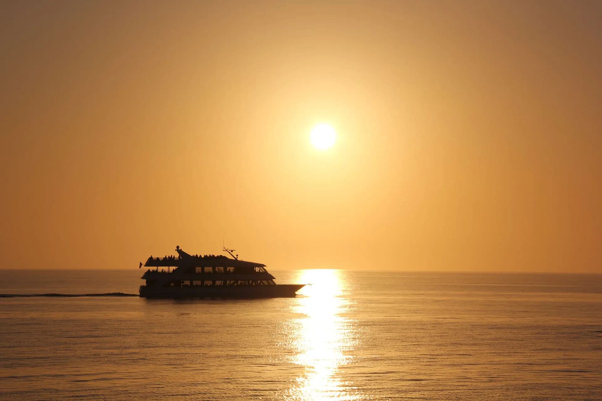 Catamaran anchored off the white sand of Playa Fantasia, a jungle-backed cove reached by boat from Jacó, Costa Rica