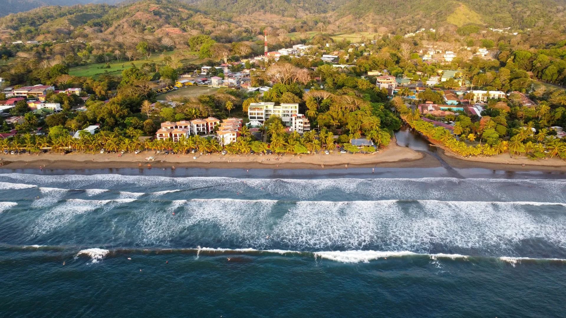 Small private speedboat anchored off a quiet beach near Jacó on Costa Rica's Pacific coast