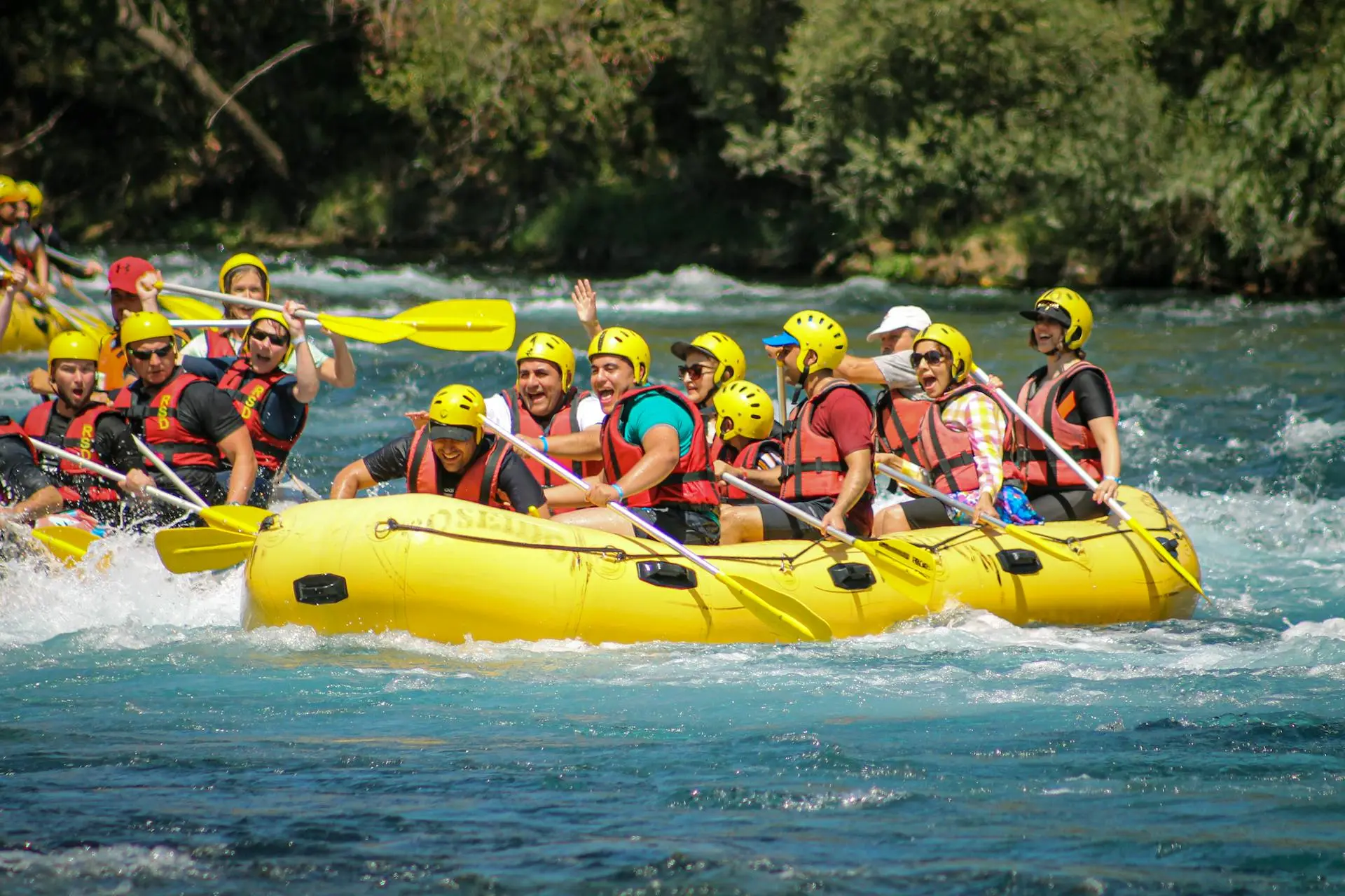 Rafters paddling through white water rapids on the Savegre River surrounded by Costa Rican rainforest