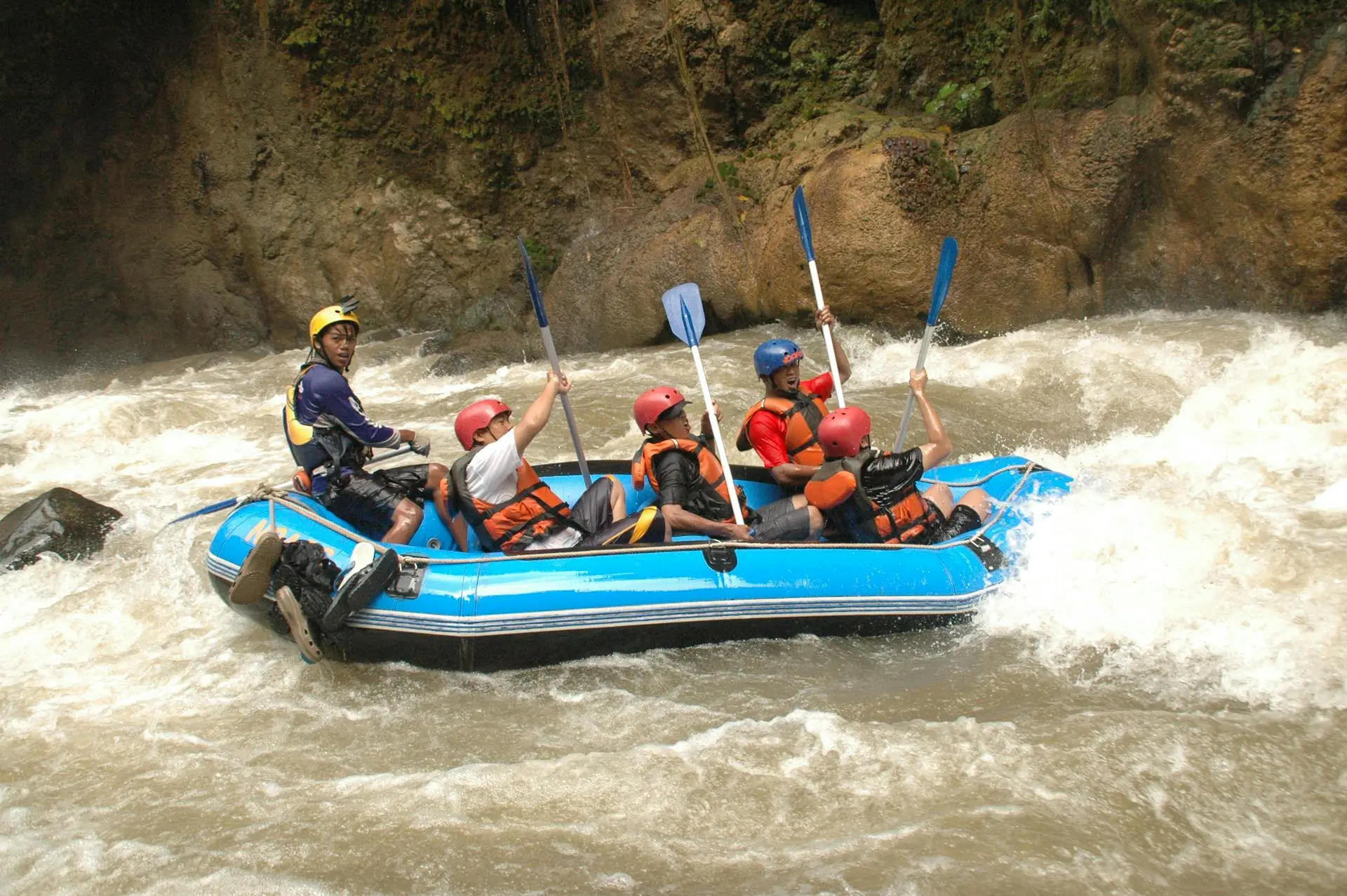 Rafters paddling through white water rapids on the Balsa River surrounded by rainforest near La Fortuna, Costa Rica