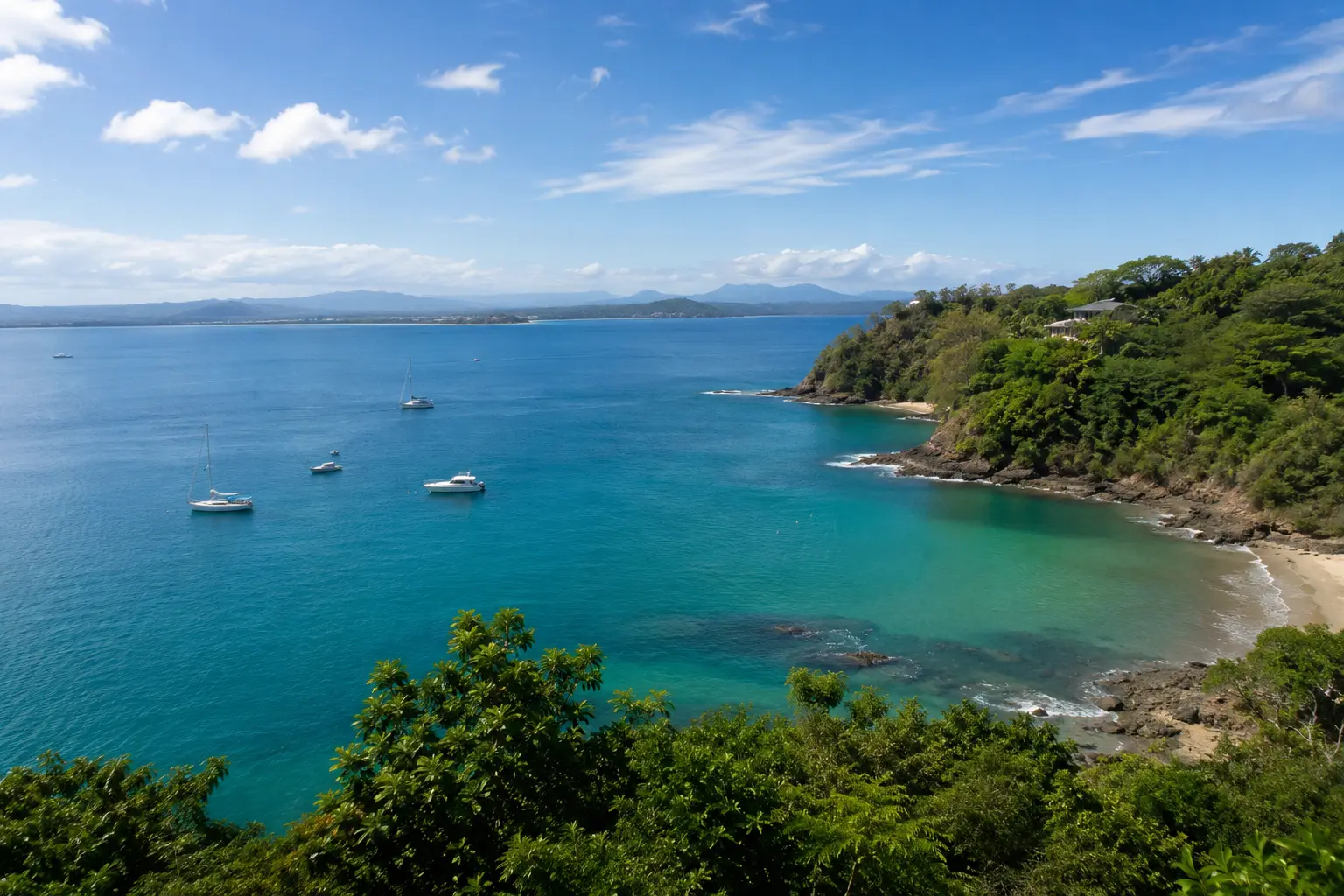 Overlooking Biesanz Bay with boats on the water near Manuel Antonio National Park, Costa Rica